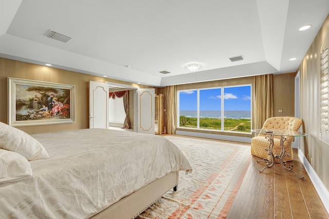 477 S Beach Rd, Jupiter Island, FL 33455 - bedroom with wood finished floors, a raised ceiling, and recessed lighting