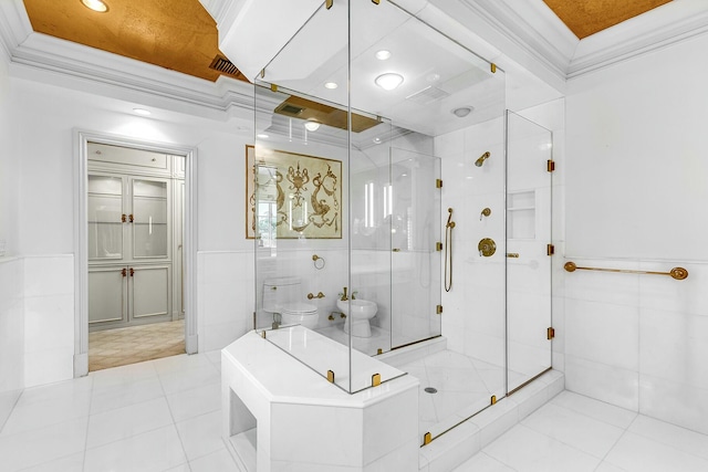 bathroom with toilet, a bidet, tile walls, and ornamental molding