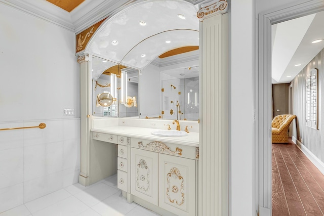 bathroom with wood-type flooring, vanity, an enclosed shower, and ornamental molding