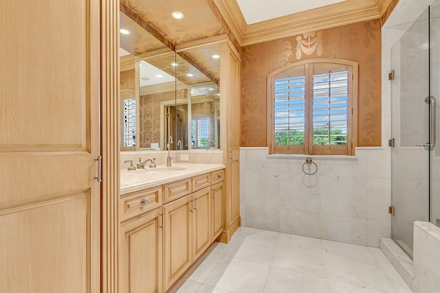 bathroom featuring vanity, a shower with door, and crown molding