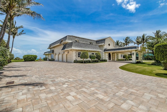 view of front of house with a front lawn and a garage