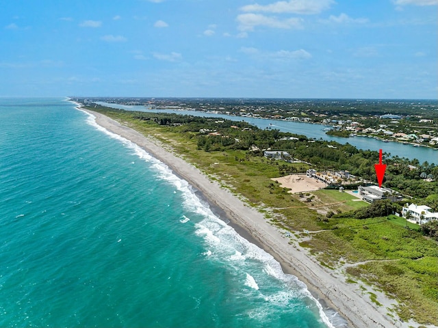 birds eye view of property with a beach view and a water view