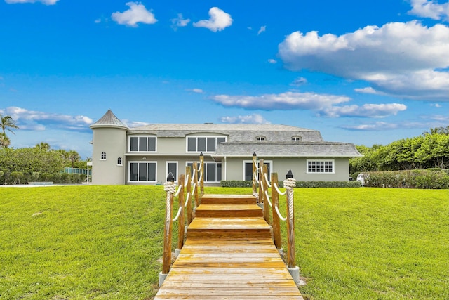 477 S Beach Rd, Jupiter Island, FL 33455 - view of front facade featuring stucco siding and a front lawn