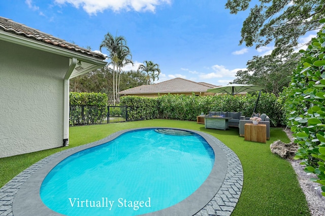 view of pool featuring outdoor lounge area and a yard