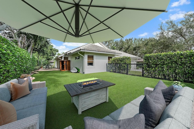 view of yard featuring an outdoor living space with a fire pit and a patio area