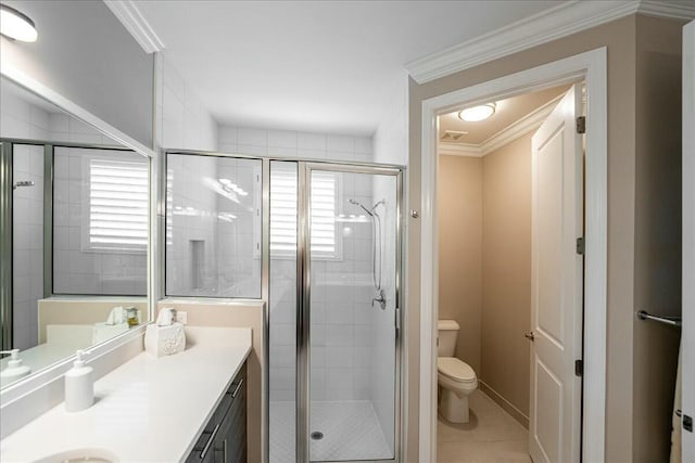 bathroom featuring tile patterned flooring, toilet, a shower with shower door, and ornamental molding