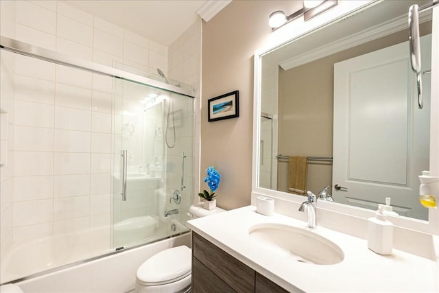 full bathroom featuring combined bath / shower with glass door, vanity, toilet, and ornamental molding