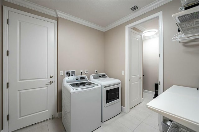 laundry room featuring independent washer and dryer, ornamental molding, and light tile patterned flooring