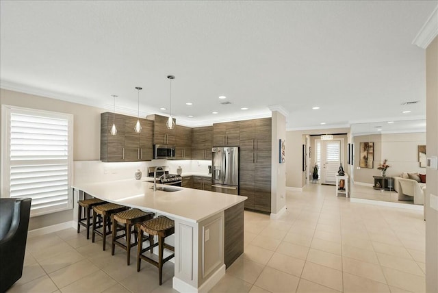 kitchen with pendant lighting, crown molding, a breakfast bar area, kitchen peninsula, and stainless steel appliances