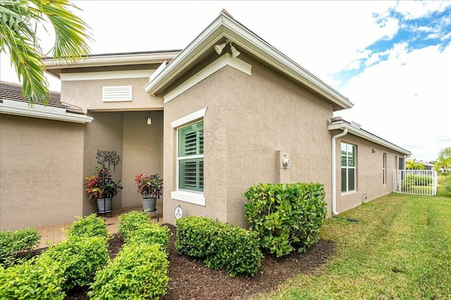 view of side of home with a lawn