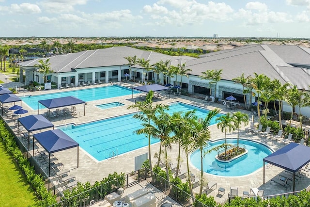 view of swimming pool with a hot tub