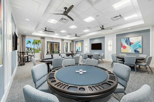 recreation room featuring a drop ceiling and light colored carpet