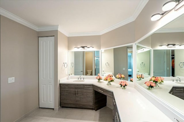 bathroom with crown molding, vanity, and toilet