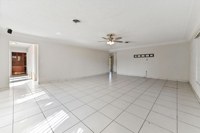 tiled empty room featuring a textured ceiling and ceiling fan