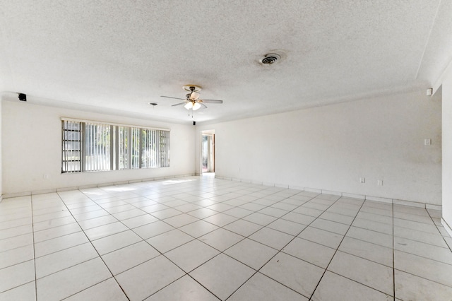 tiled spare room with ceiling fan