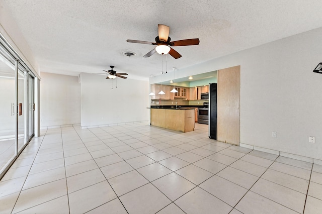 kitchen featuring pendant lighting, appliances with stainless steel finishes, a textured ceiling, ceiling fan, and light tile patterned floors