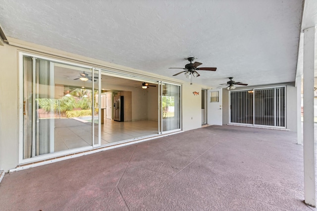 view of patio featuring ceiling fan