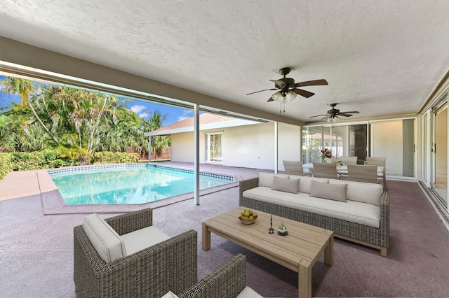 view of swimming pool with ceiling fan, a patio, and an outdoor hangout area