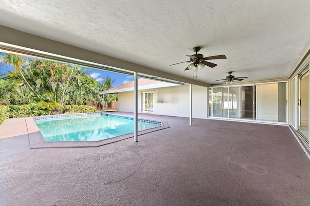 view of swimming pool with ceiling fan and a patio