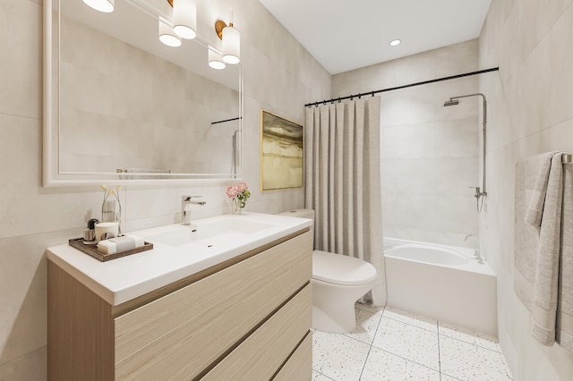 full bathroom featuring vanity, toilet, tile walls, and shower / bath combo