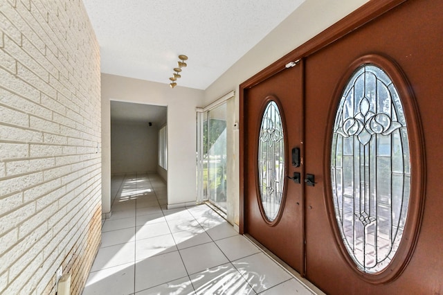 entryway featuring a textured ceiling and light tile patterned floors