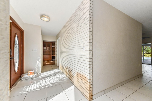 hallway featuring light tile patterned floors