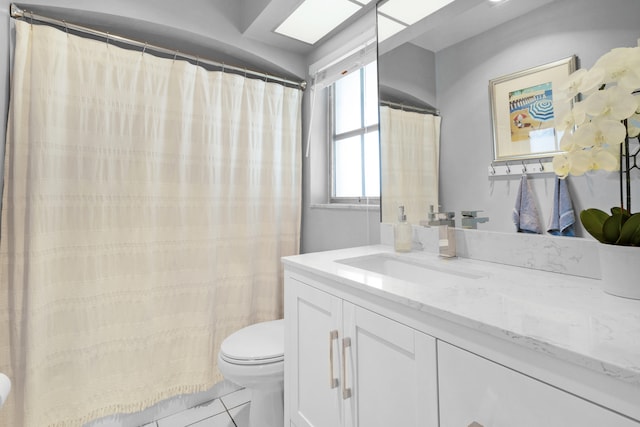 bathroom featuring tile patterned flooring, vanity, and toilet