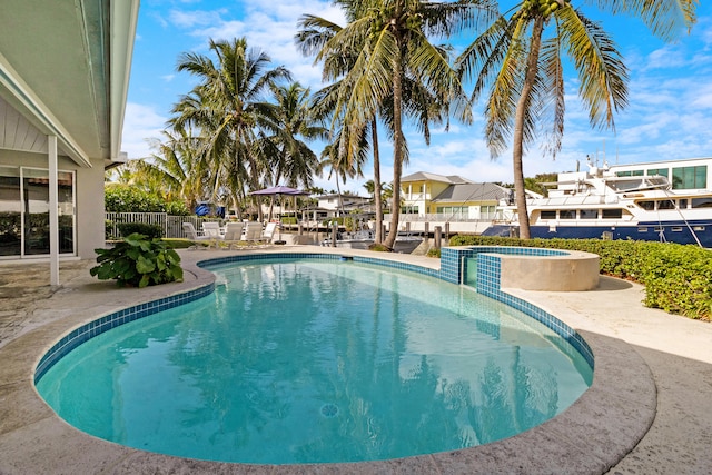 view of pool featuring a patio area and an in ground hot tub