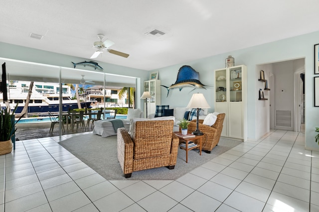 tiled living room with ceiling fan