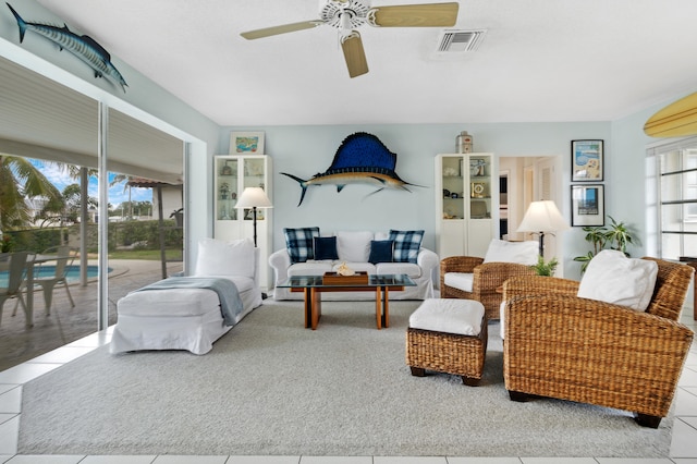 living room with light tile patterned floors and ceiling fan