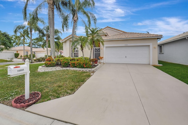 mediterranean / spanish-style house featuring a front lawn and a garage