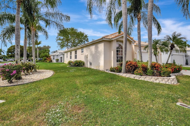 view of property exterior featuring a garage and a yard