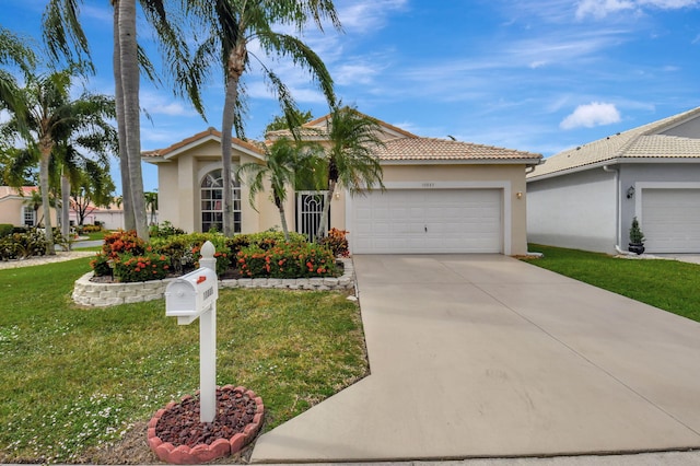 mediterranean / spanish-style house with a garage and a front lawn