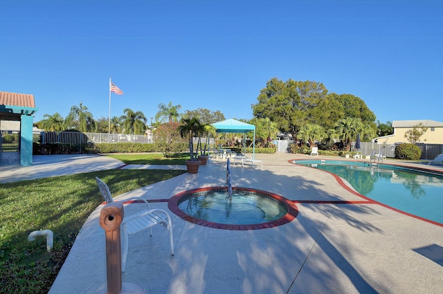 view of swimming pool featuring a patio area, an in ground hot tub, and a yard