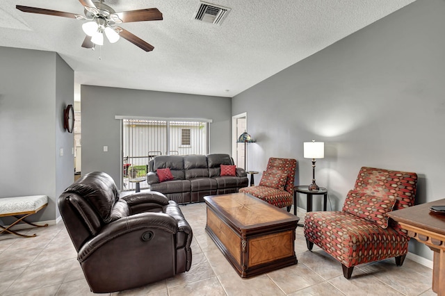 tiled living room with ceiling fan and a textured ceiling