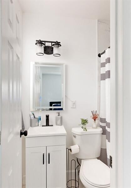 bathroom featuring vanity and toilet