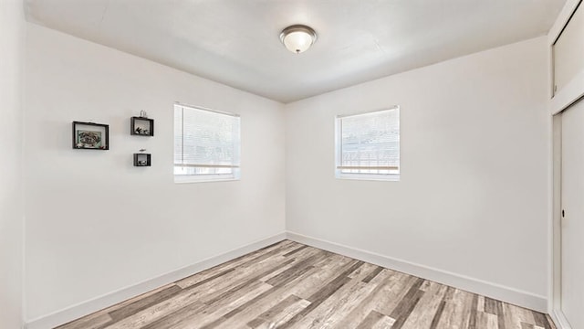 spare room with plenty of natural light and light wood-type flooring