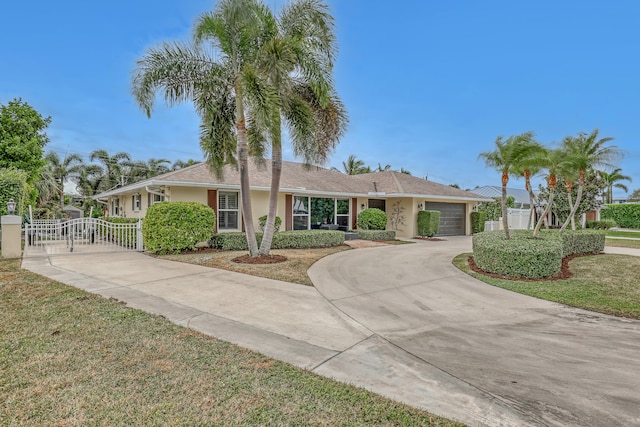 single story home featuring a garage and a front lawn