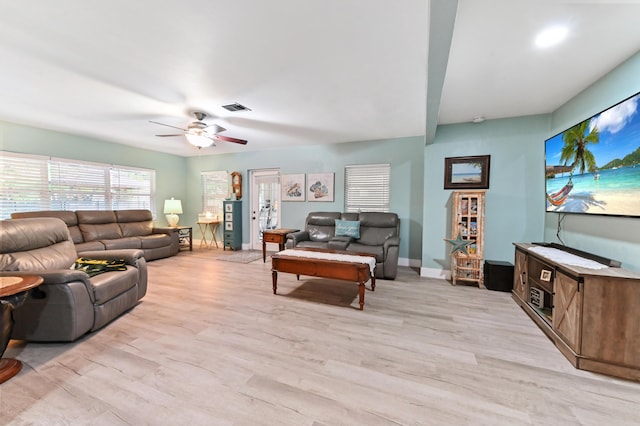 living room featuring ceiling fan and light hardwood / wood-style flooring