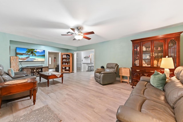 living room featuring ceiling fan and light wood-type flooring