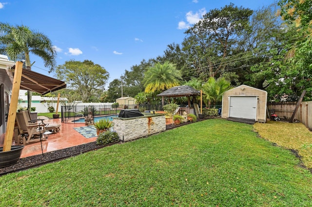 view of yard featuring a storage shed, a gazebo, a patio area, and a fenced in pool