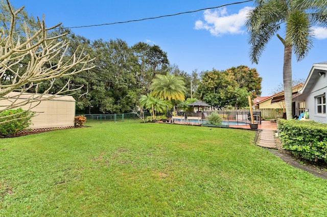 view of yard with a fenced in pool