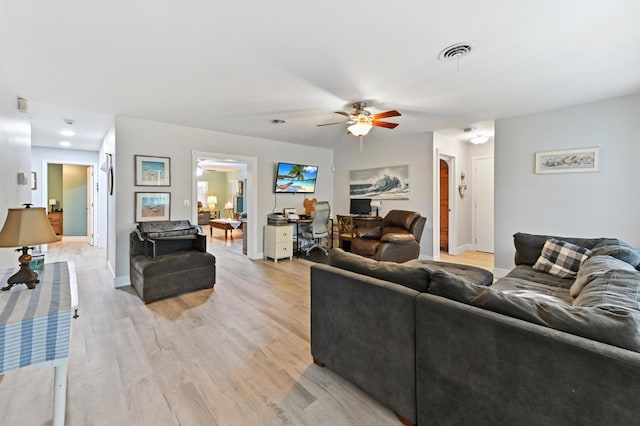 living room with ceiling fan and light hardwood / wood-style floors