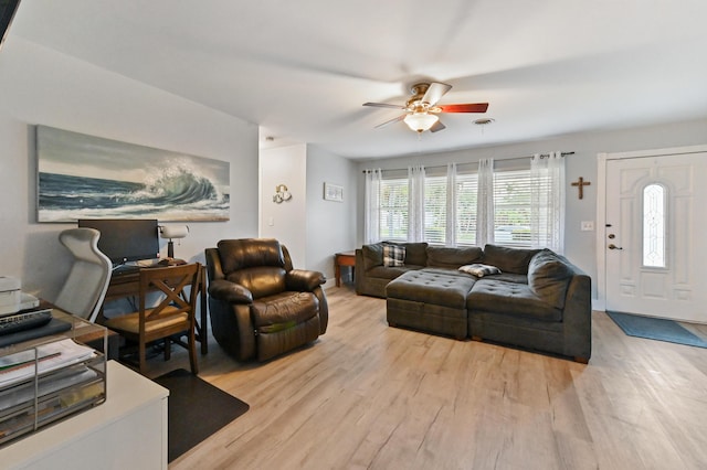 living room featuring ceiling fan and light hardwood / wood-style floors