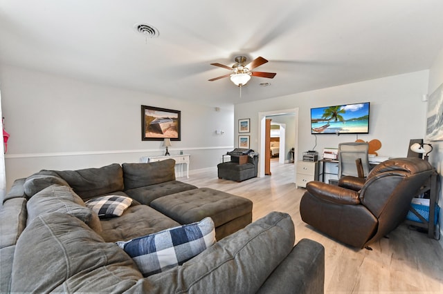 living room featuring ceiling fan and light hardwood / wood-style flooring