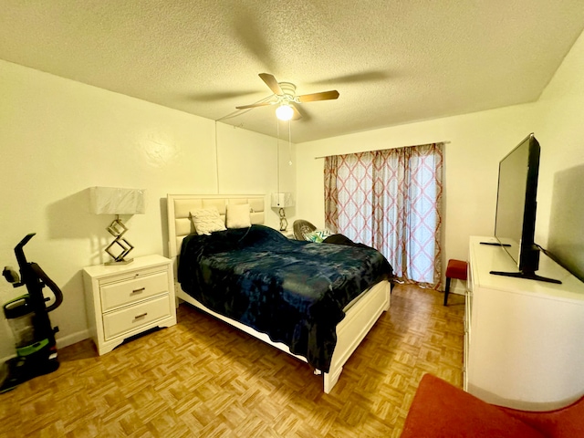 bedroom with a textured ceiling, light parquet floors, and ceiling fan