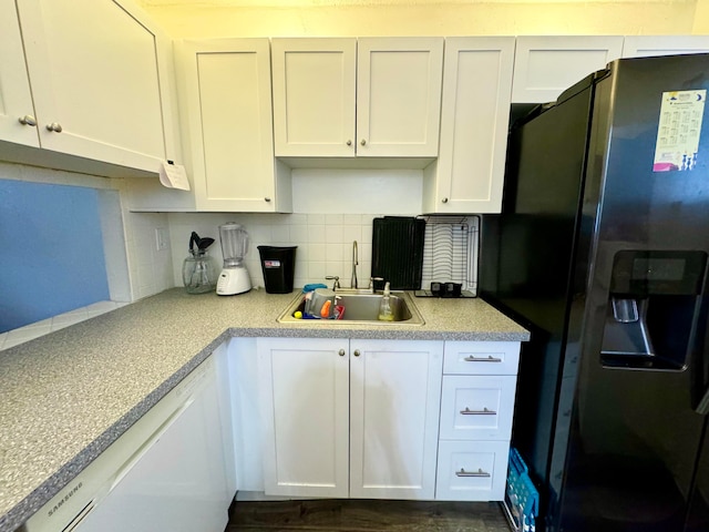 kitchen featuring white cabinetry and stainless steel refrigerator with ice dispenser