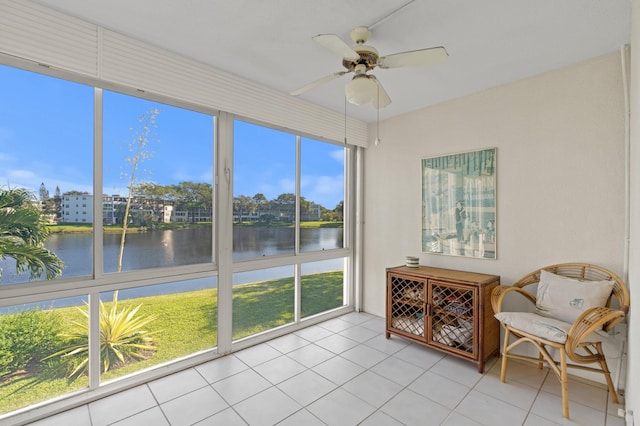 unfurnished sunroom with a water view and ceiling fan