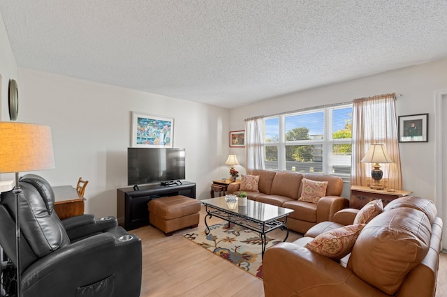 living room featuring a textured ceiling and light wood-type flooring