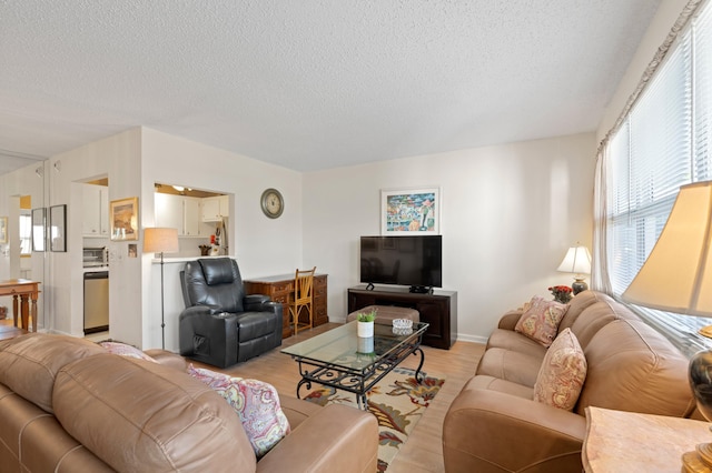 living room featuring light hardwood / wood-style floors and a textured ceiling